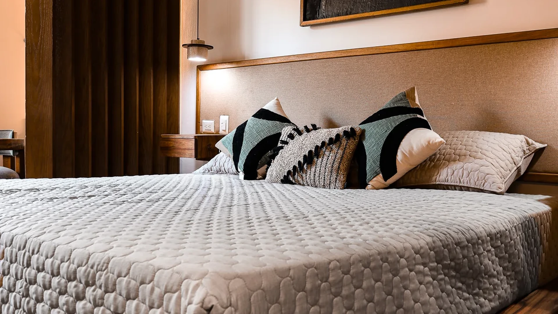 View of Modern Bedroom at Duna, showcasing Wood Bed Frame, Stylish Interior.