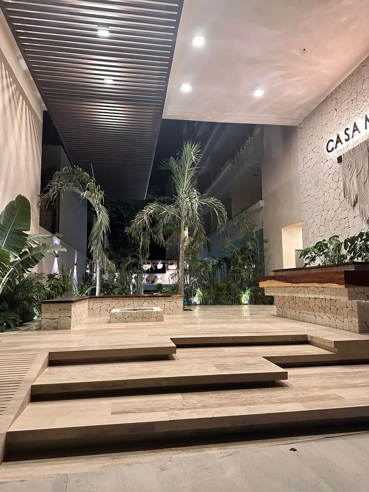Image of Lounge at Casa Makram, featuring Modern Architectural Entrance, Tropical Landscaping.