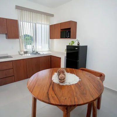 View of Modern Kitchen at Triángulo, showcasing Compact Kitchen, Wood Cabinetry.