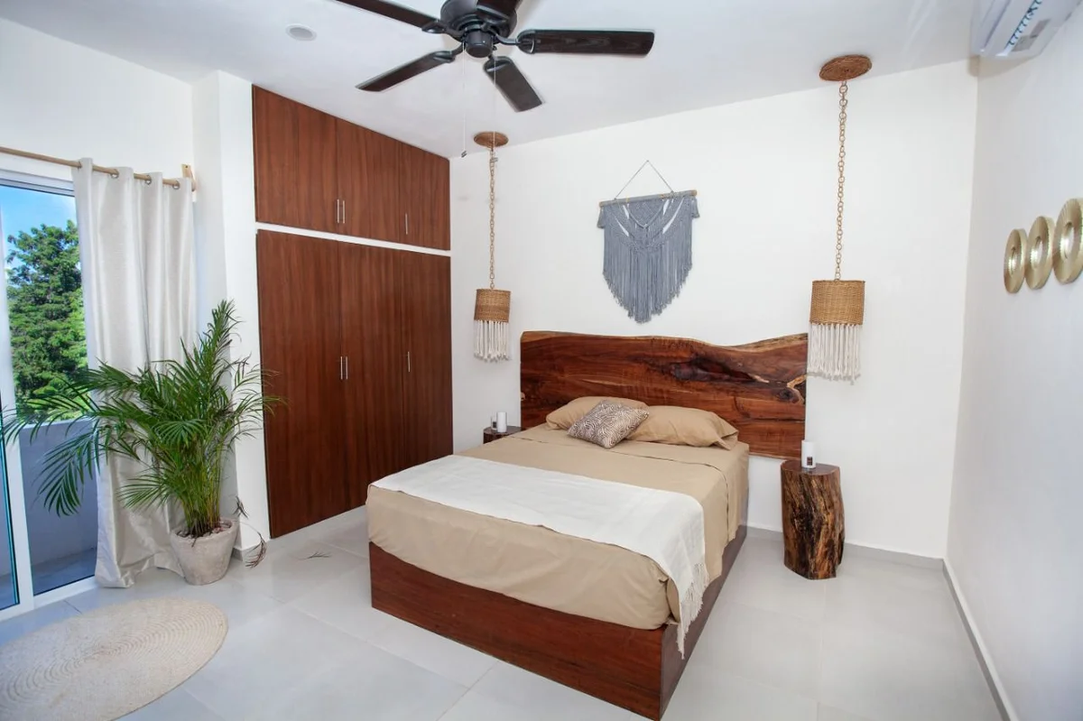 View of Bedroom at Triángulo, showcasing Modern Decor, Wooden Headboard.
