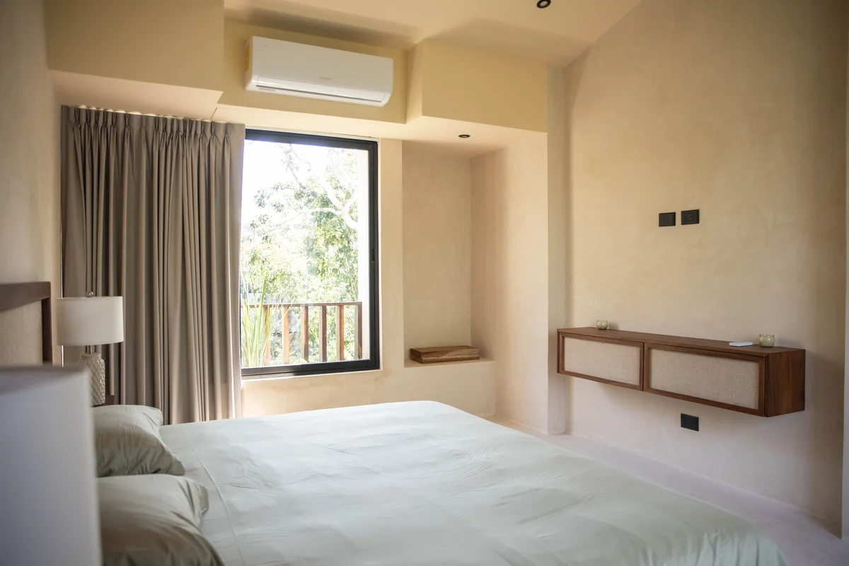 View of Modern Bedroom at Afra Jungle, showcasing Natural Light, Neutral Decor.