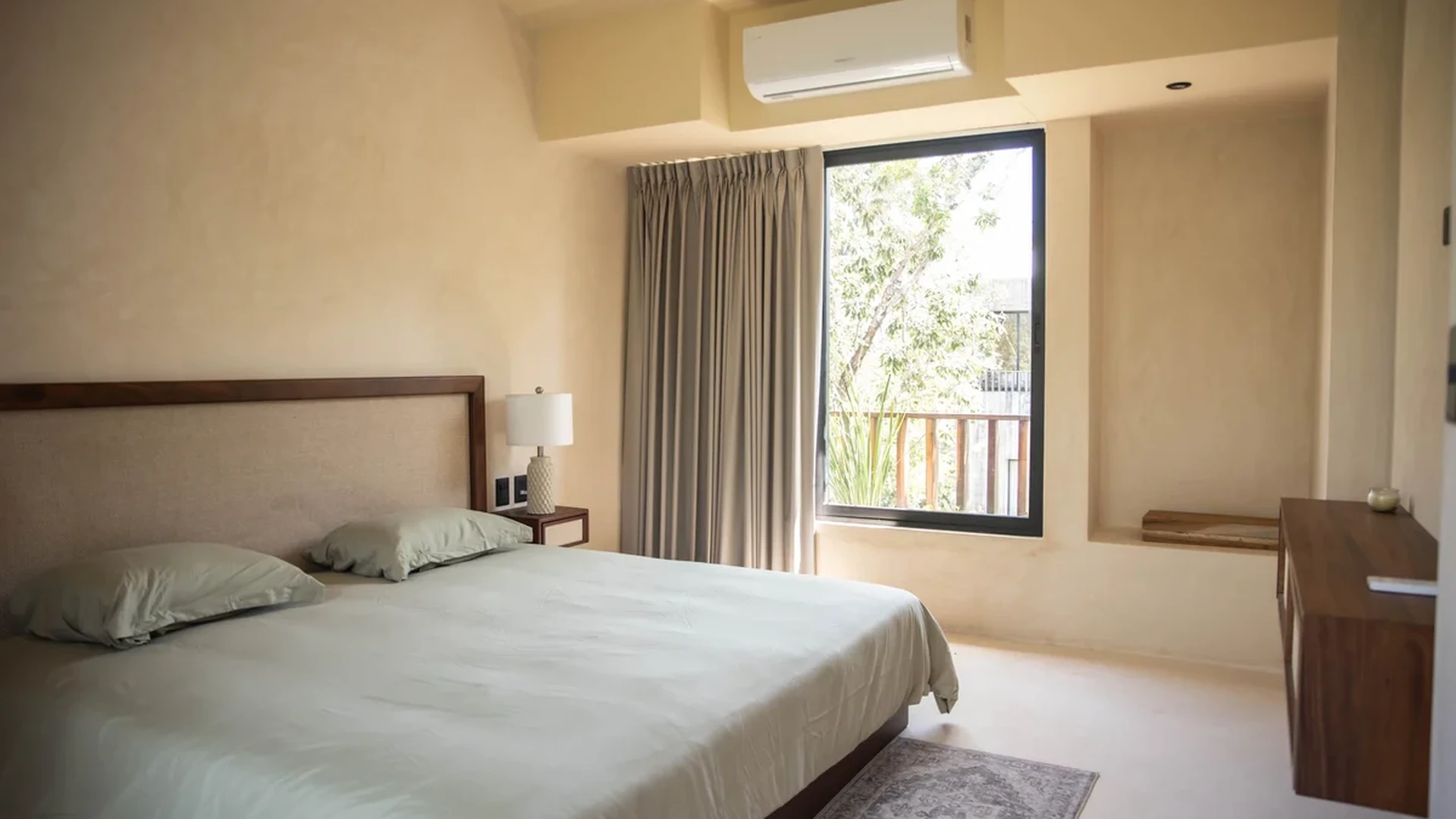View of Modern Bedroom at Afra Jungle, showcasing Neutral Decor, Natural Light.