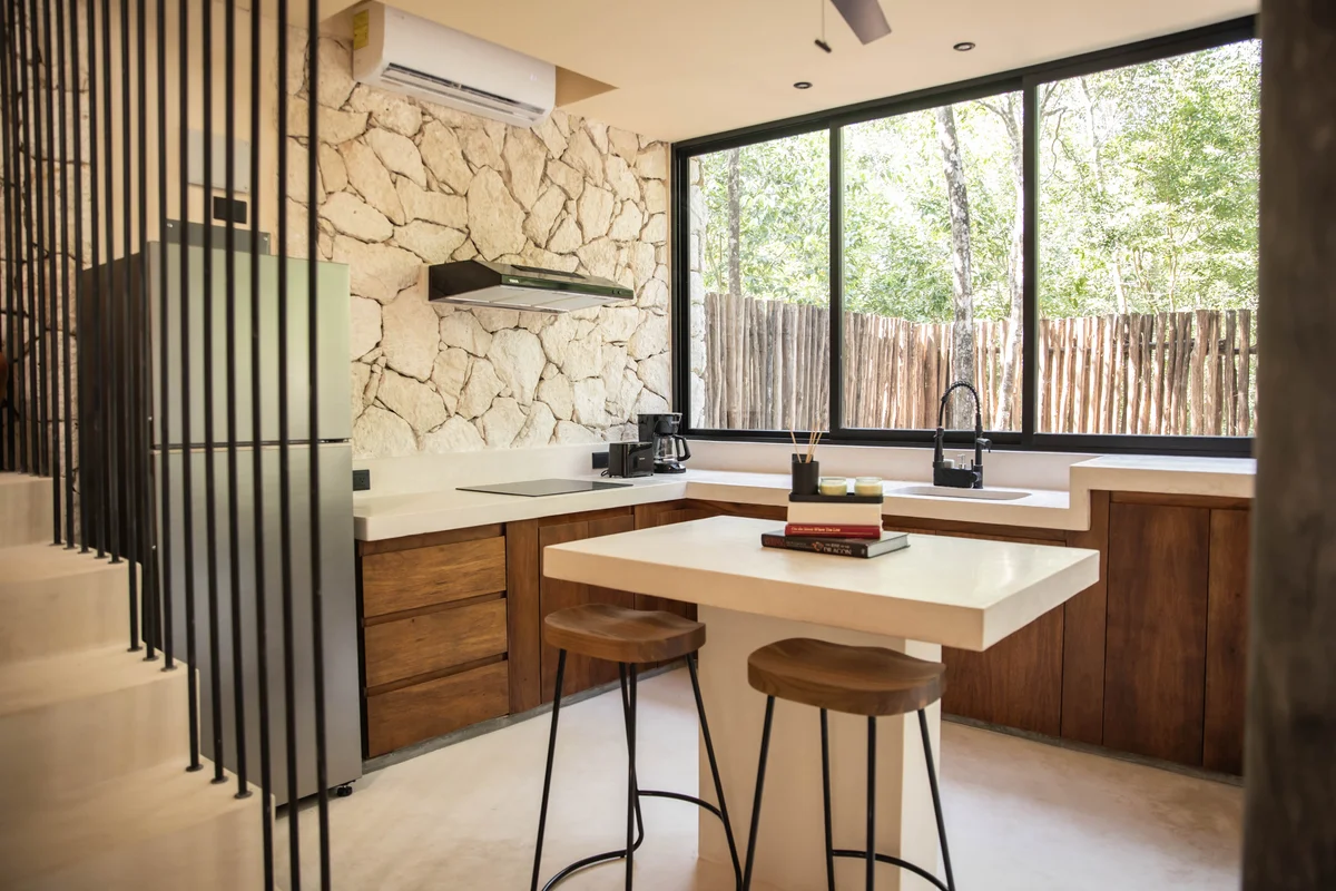 View of Modern Kitchen at Afra Jungle, showcasing Stone Accent Wall, Wooden Cabinetry.
