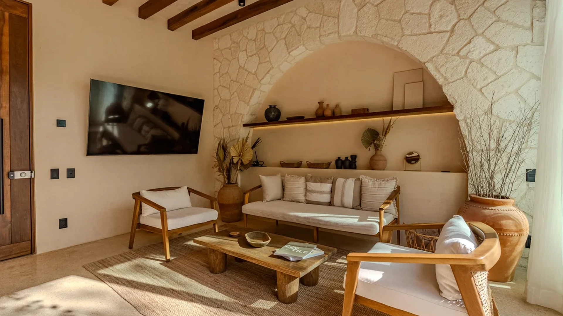 Image of a Living Room, featuring Stone Accent Wall and Exposed Wood Beams.