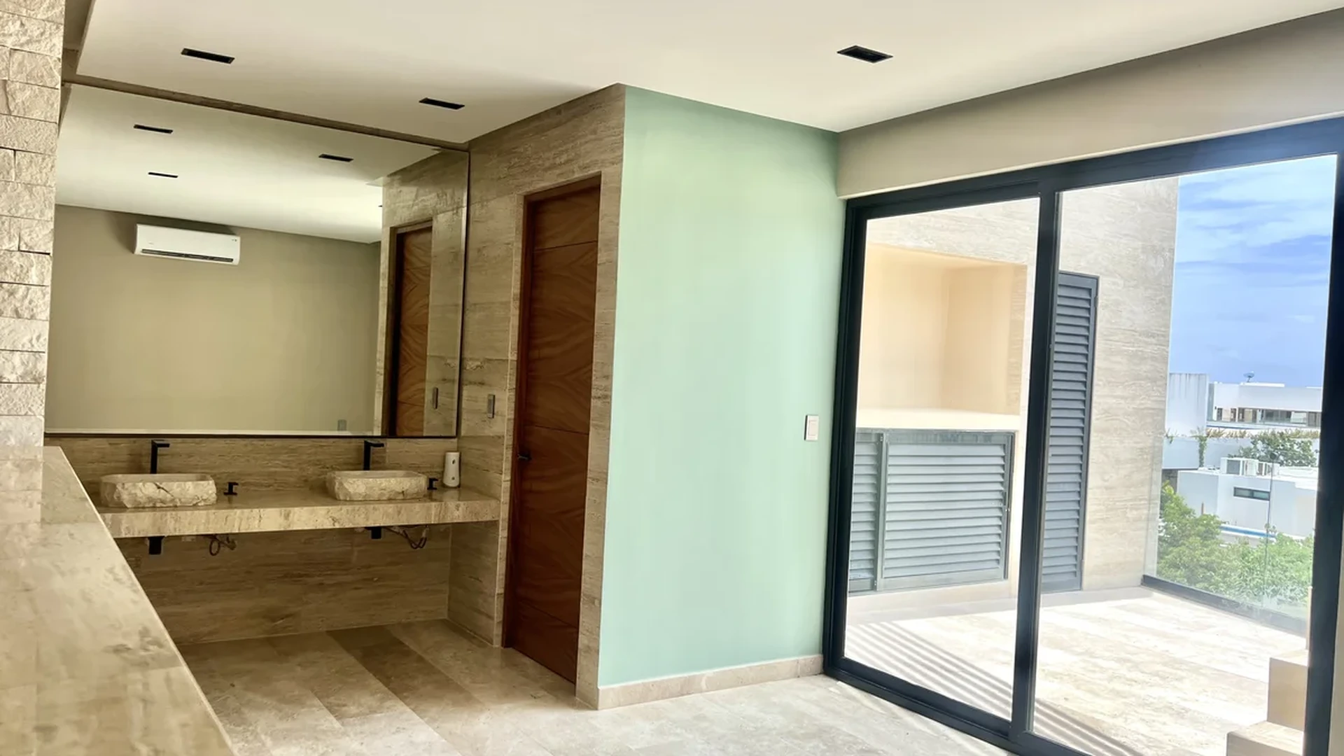 View of Modern Bathroom at Amaru, showcasing Dual Vanity, Travertine Tile.