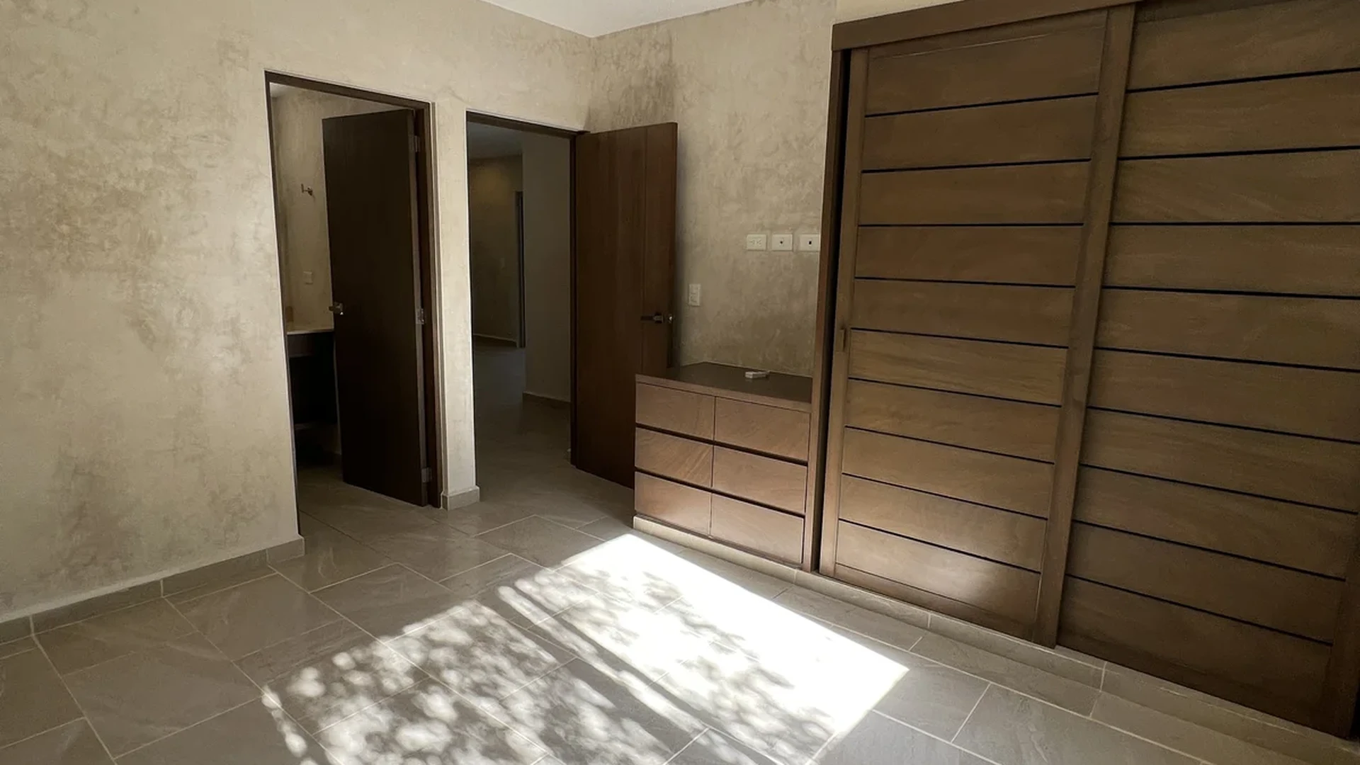 View of Unfurnished Bedroom at Carmela, showcasing Spacious Room, Tile Flooring.