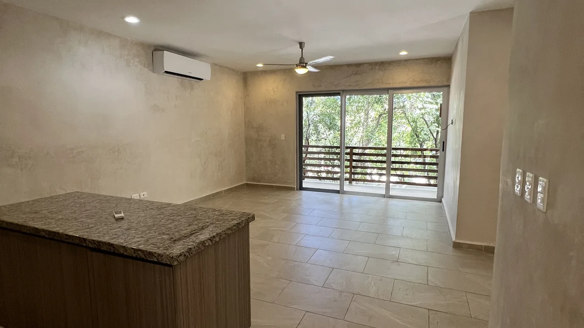 View of Open Concept Living at Carmela, showcasing Granite Countertop, Tiled Flooring.