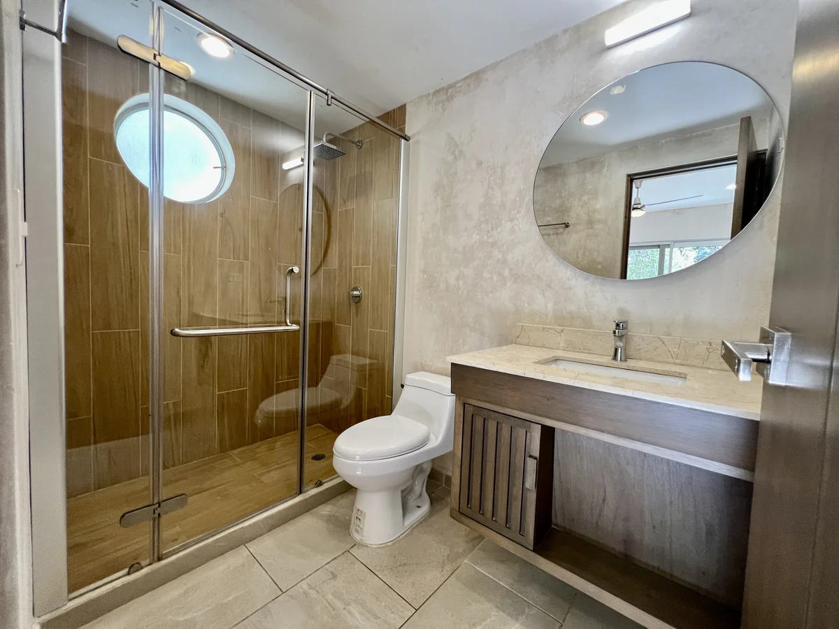 View of Modern Bathroom at Carmela, showcasing Walk-in Shower, Vanity Sink.