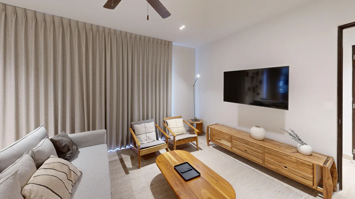View of Modern Living Room at Costa Caribe, showcasing Neutral Decor, Wood Furniture.