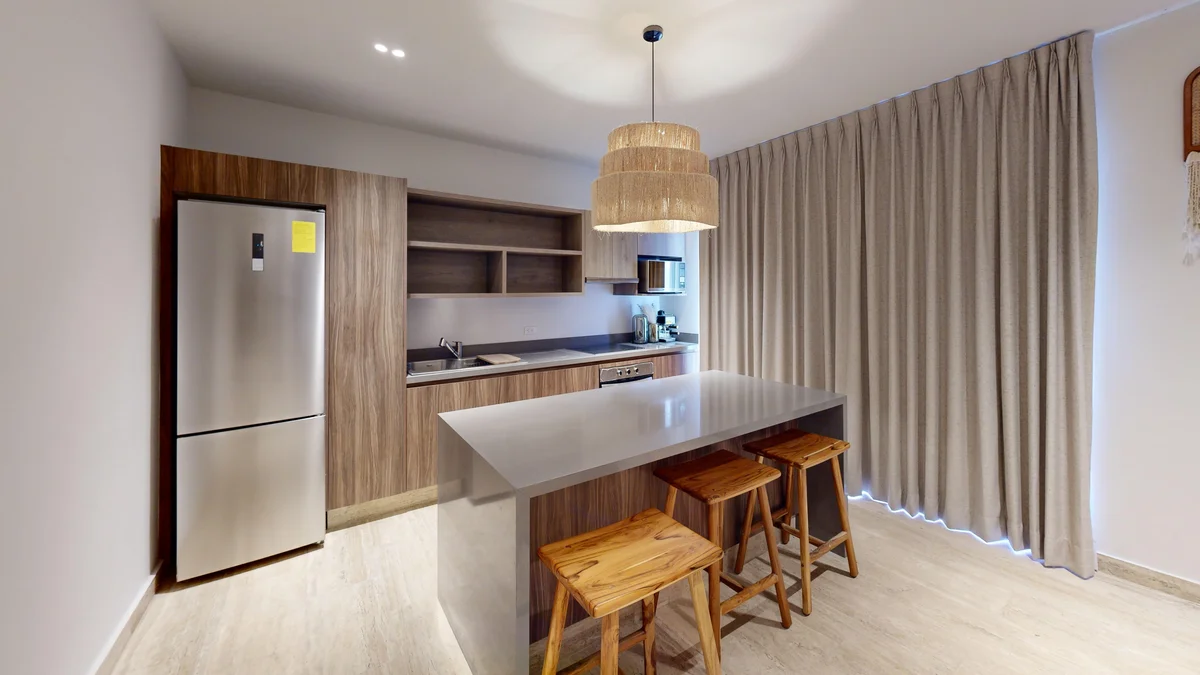 View of Modern Kitchen at Costa Caribe, showcasing Kitchen Island, Wood Cabinetry.