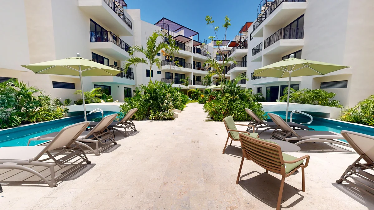 Image of Swimming Pool at Costa Caribe, featuring Resort-style Pool, Tropical Landscaping.