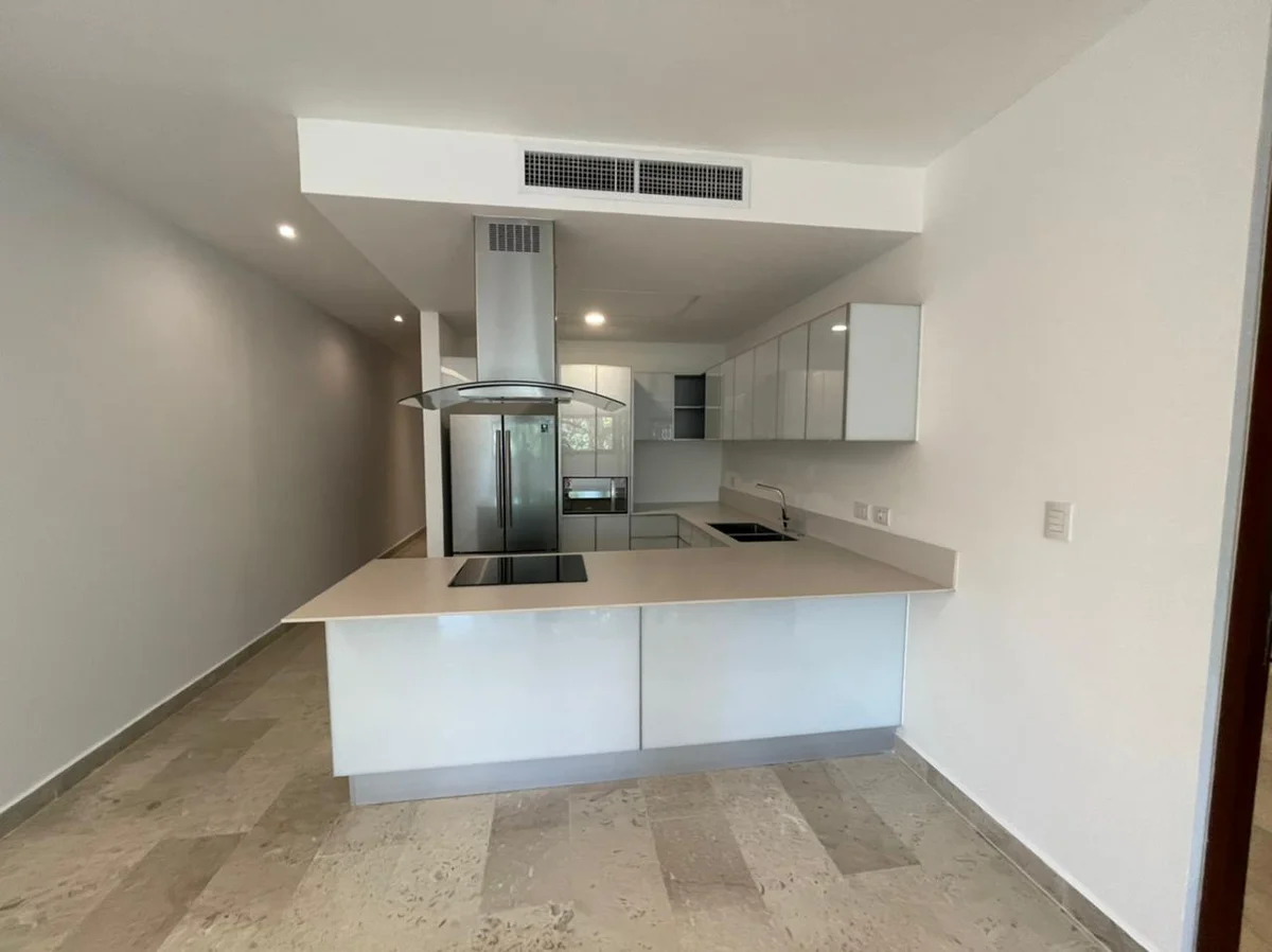 View of Modern Kitchen at Cruz con Mar, showcasing White Kitchen, Stainless Steel Appliances.