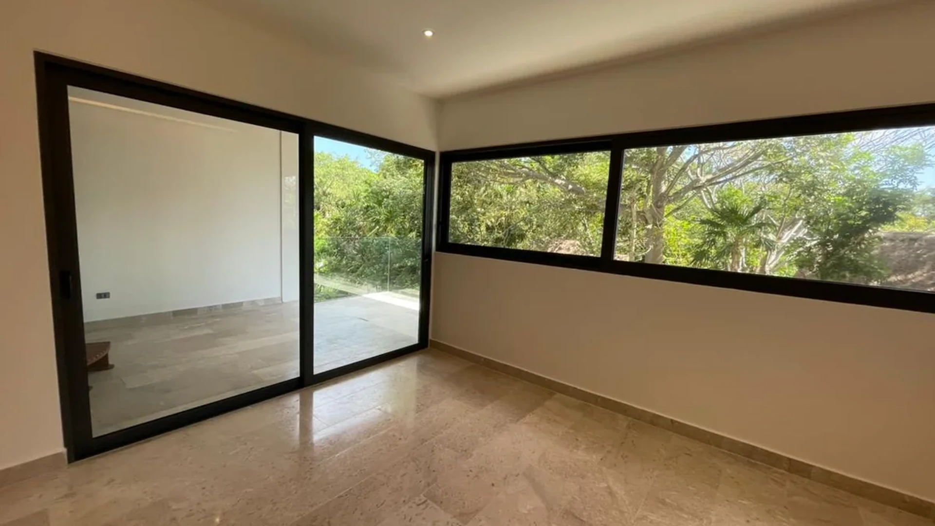 View of Unfurnished Room at Cruz con Mar, showcasing Spacious Interior, Large Windows.