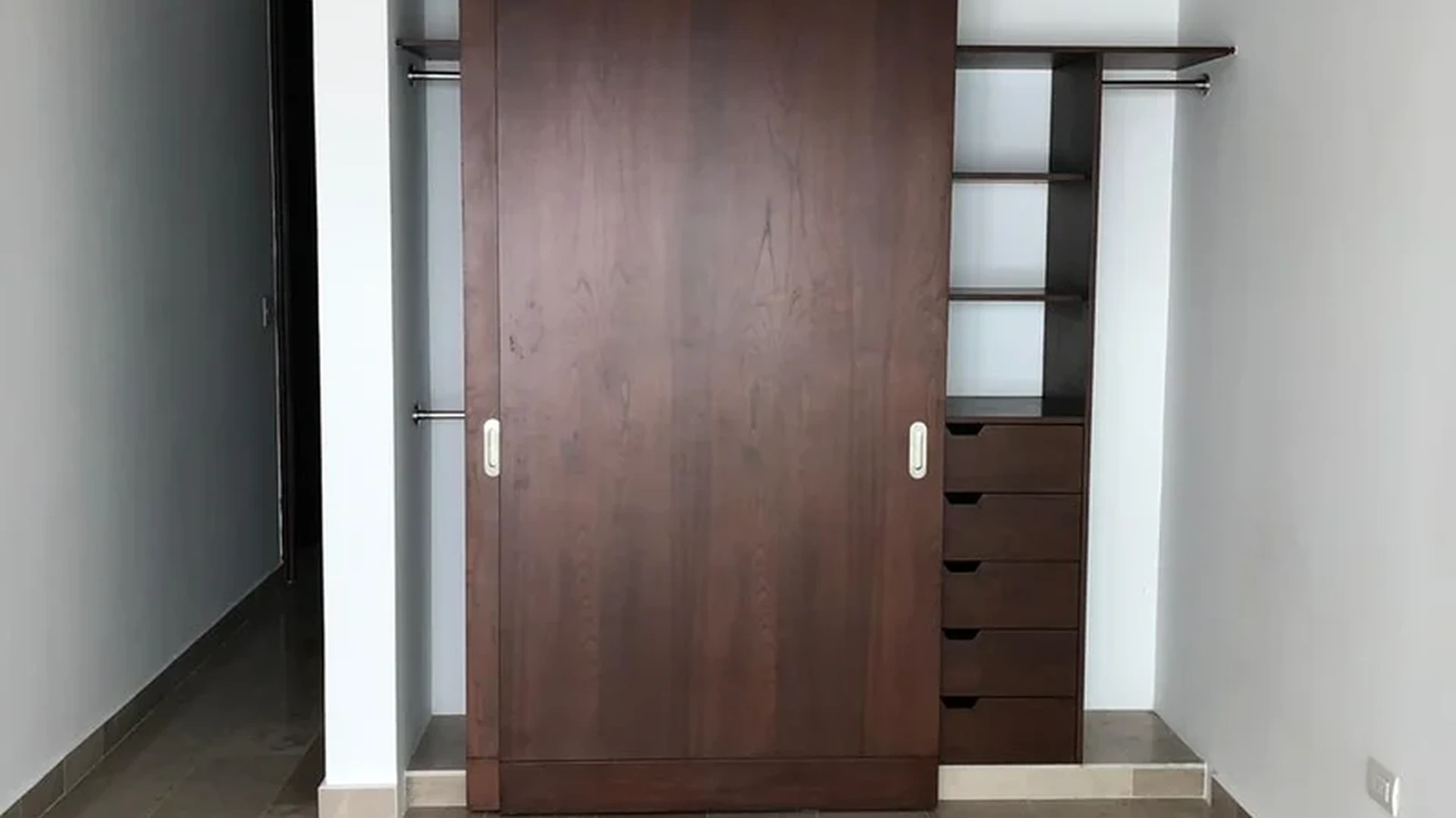 View of Built-in Wardrobe at Cruz con Mar, showcasing Modern Closet, Tile Flooring.