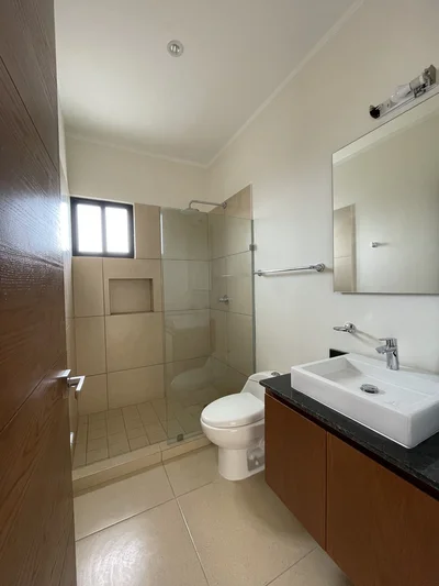 View of Modern Bathroom at Inzignia, showcasing Contemporary Design, Glass Shower.