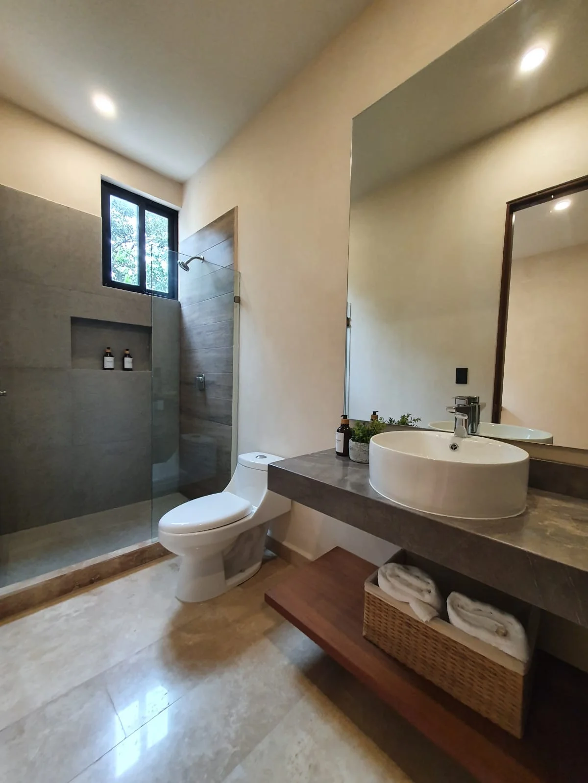 View of Modern Bathroom at Jungle Park Residences, showcasing Walk-in Shower, Floating Vanity.
