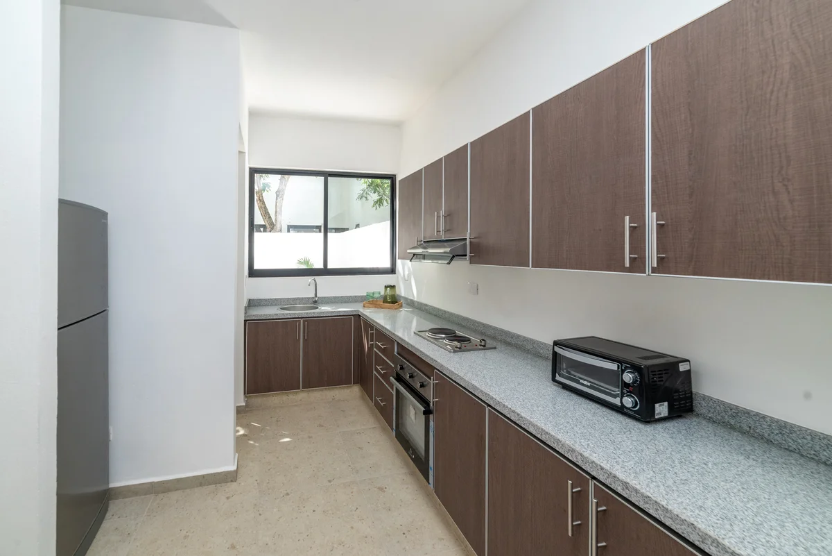 View of Modern Kitchen at Kim-Koba, showcasing Residential Kitchen, Brown Cabinets.