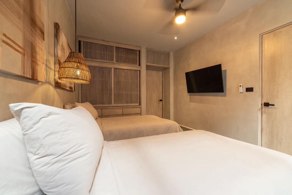View of Modern Bedroom at NEEA, showcasing Neutral Decor, Wall-mounted TV.