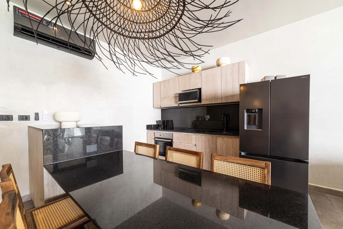 View of Modern Kitchen at NEEA, showcasing Granite Countertop, Black Appliances.