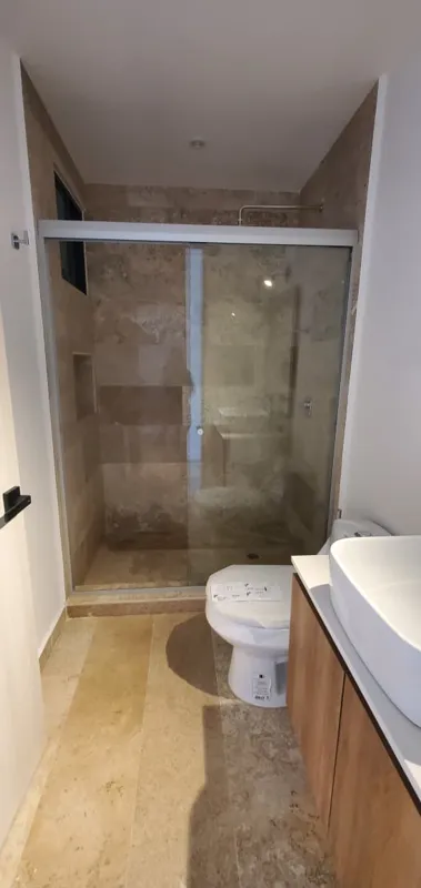 A collection of interior and balcony photos from Lik Xelba, showcasing a finished bedroom with a wooden wardrobe, ceiling fan, air conditioning, and a balcony with a spiral staircase, alongside a modern bathroom with a white sink, toilet, and glas...