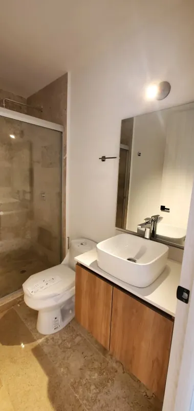 A collection of interior and balcony photos from Lik Xelba, showcasing a finished bedroom with a wooden wardrobe, ceiling fan, air conditioning, and a balcony with a spiral staircase, alongside a modern bathroom with a white sink, toilet, and glas...