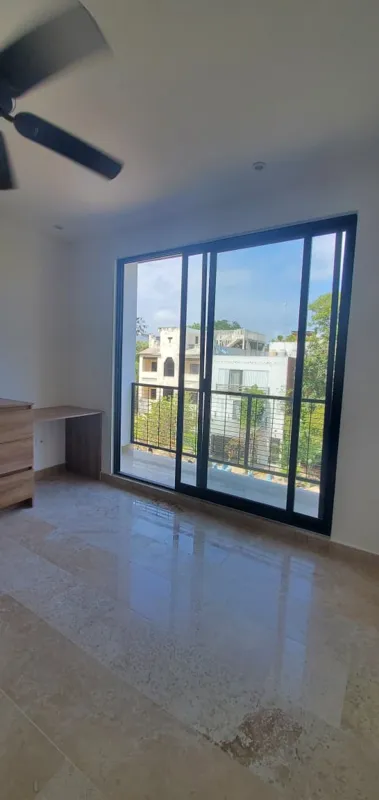 A collection of interior and balcony photos from Lik Xelba, showcasing a finished bedroom with a wooden wardrobe, ceiling fan, air conditioning, and a balcony with a spiral staircase, alongside a modern bathroom with a white sink, toilet, and glas...