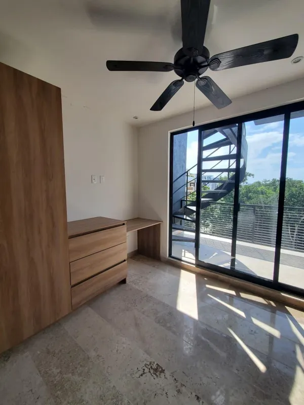 A collection of interior and balcony photos from Lik Xelba, showcasing a finished bedroom with a wooden wardrobe, ceiling fan, air conditioning, and a balcony with a spiral staircase, alongside a modern bathroom with a white sink, toilet, and glas...