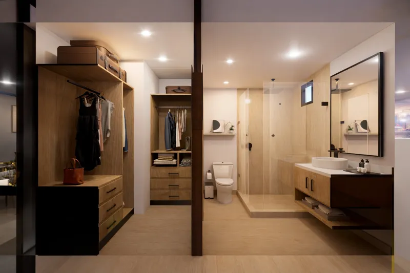 A beautifully rendered modern living room featuring a light-colored sofa, a wooden coffee table, and a ceiling fan, with a large sliding glass door opening to a balcony that offers a panoramic view of the turquoise Caribbean Sea and lush palm trees.