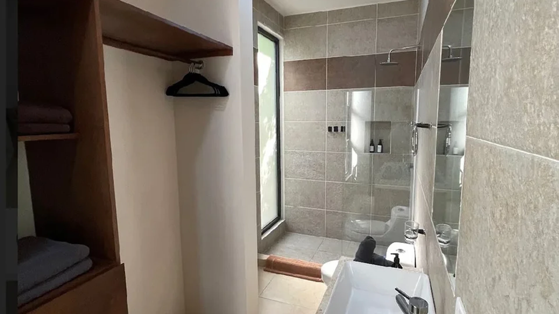 View of Modern Bathroom at Akasha Homes, showcasing Walk-in Shower, Vanity Sink.