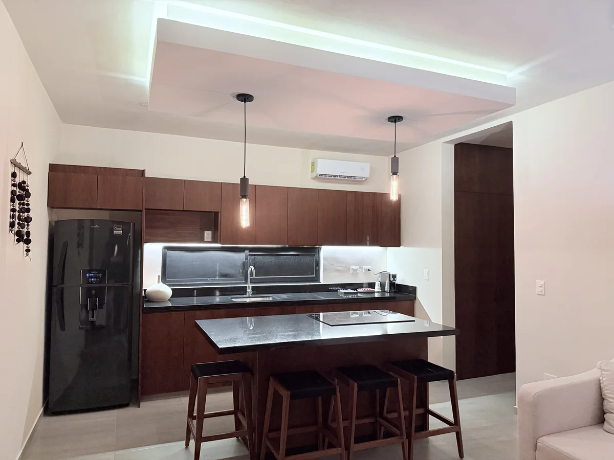 View of Modern Kitchen at AAK, showcasing Kitchen Island, Dark Wood Cabinetry.