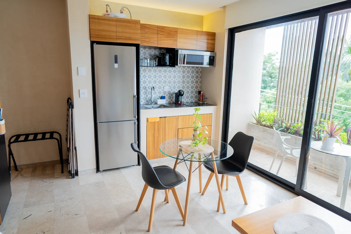 View of Modern Kitchenette at Kaahal, showcasing Compact Dining, Studio Living.
