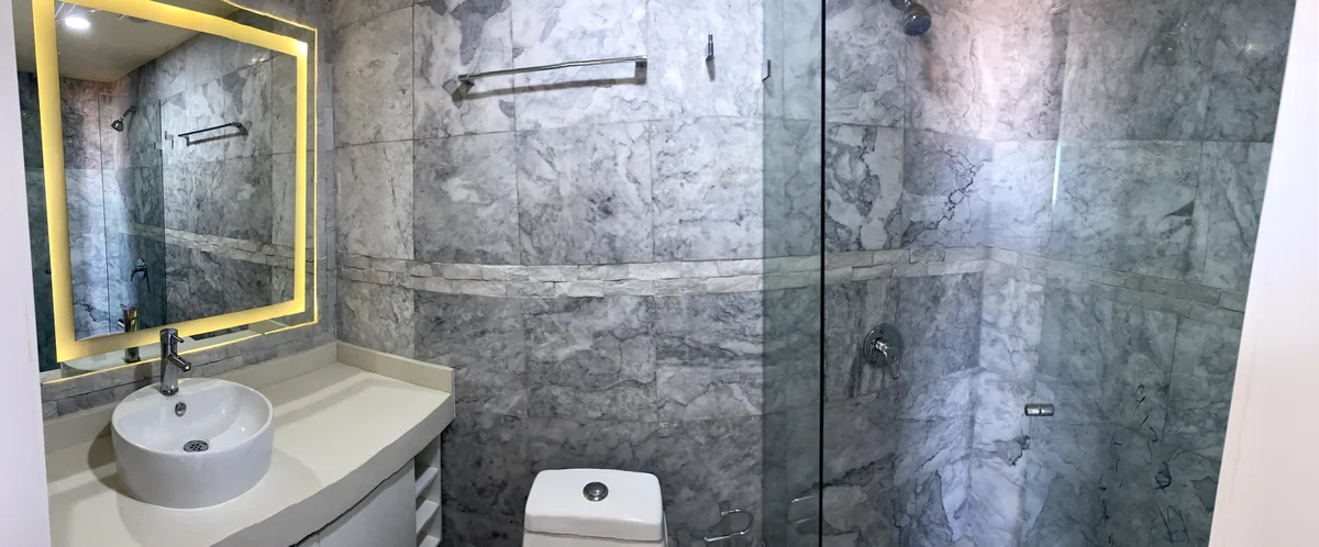 View of Modern Bathroom at Polo 5ta, showcasing Marble Tiling, Glass Shower.