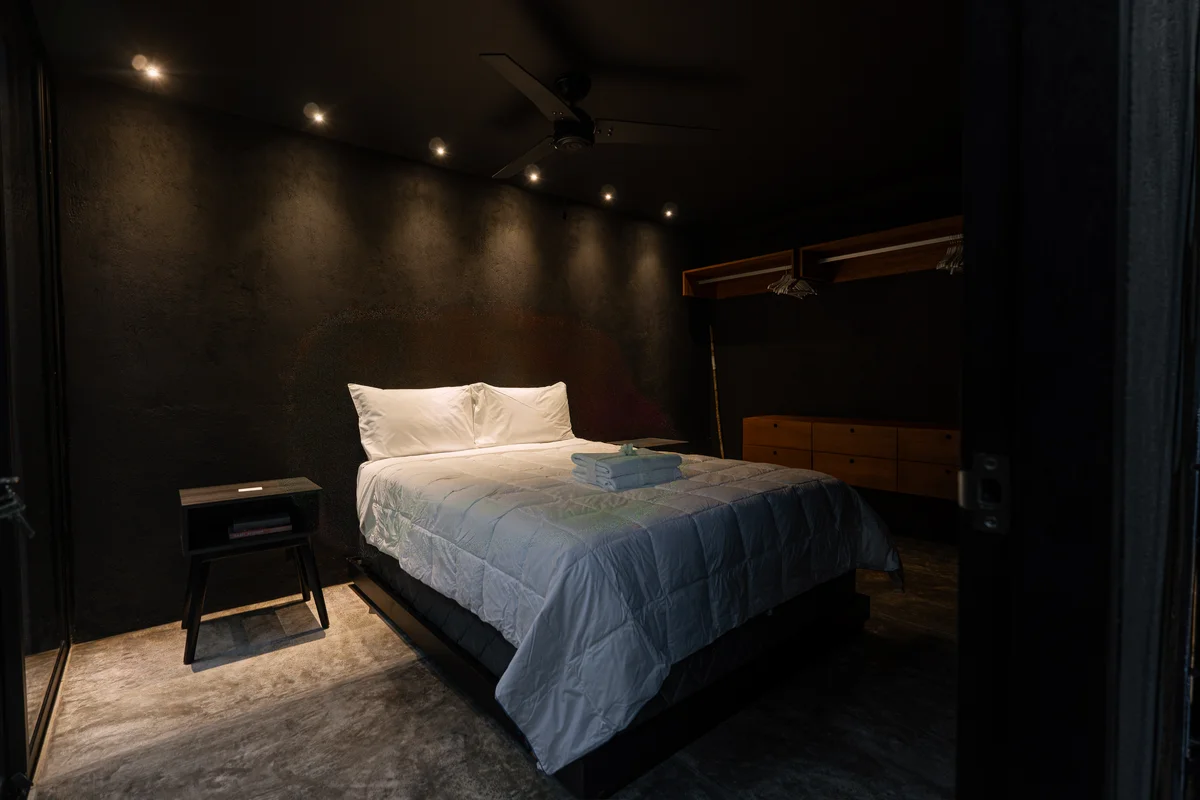 View of Modern Bedroom at Tree60, showcasing Dark Aesthetic, Minimalist Design.