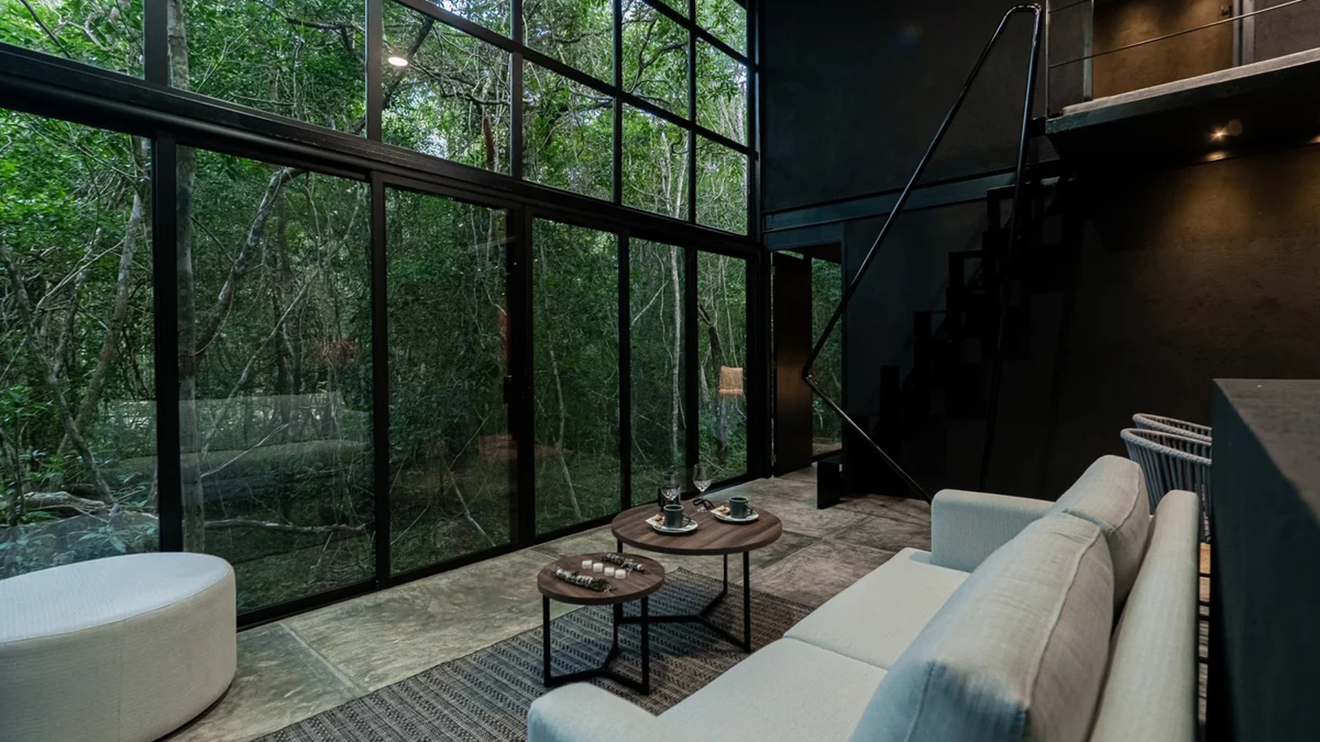 View of Modern Living Room at Tree60, showcasing Forest View, Floor-to-Ceiling Windows.
