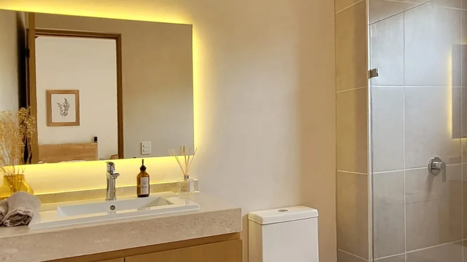 View of Modern Bathroom at Fabula, showcasing Floating Vanity, Backlit Mirror.