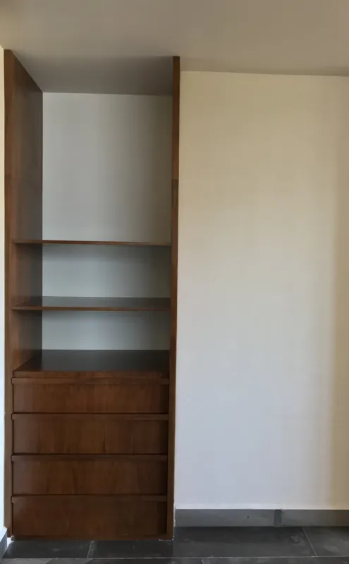 A series of interior photographs from Humana's unit 302A, displaying a fully equipped modern kitchen with dark grey upper cabinets, wooden lower cabinets, a stainless steel refrigerator, and a black countertop with an integrated sink. Also feature...