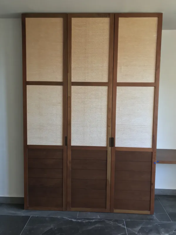 A series of interior photographs from Humana's unit 302A, displaying a fully equipped modern kitchen with dark grey upper cabinets, wooden lower cabinets, a stainless steel refrigerator, and a black countertop with an integrated sink. Also feature...