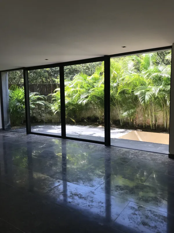 A series of high-resolution photographs displaying the completed interiors and private outdoor spaces of Humana's residential units. Images include a contemporary kitchen with dark grey and wood cabinets, a large island, and stainless steel applia...