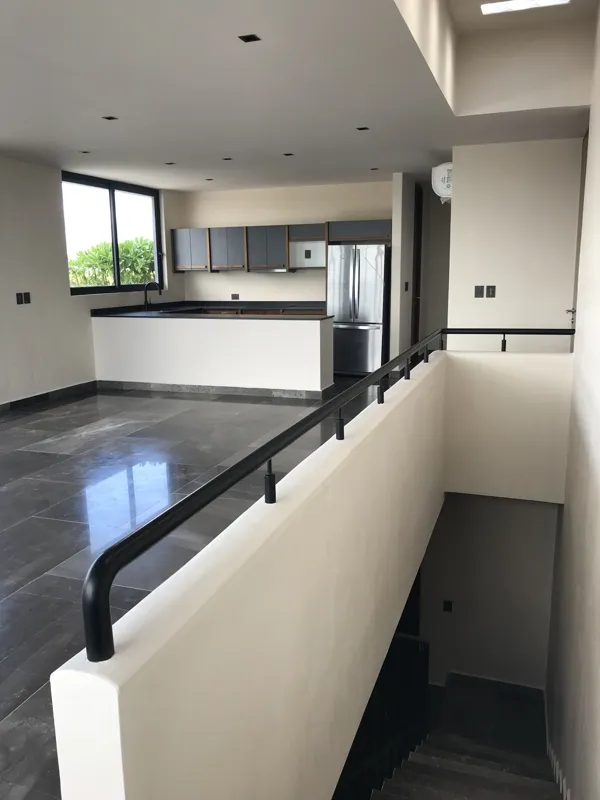 A series of eight photographs depicting the finished interiors and private rooftop amenities of a residential unit within the Humana development in Tulum. Images include a spacious living area with dark tiled floors and large glass doors, a modern...