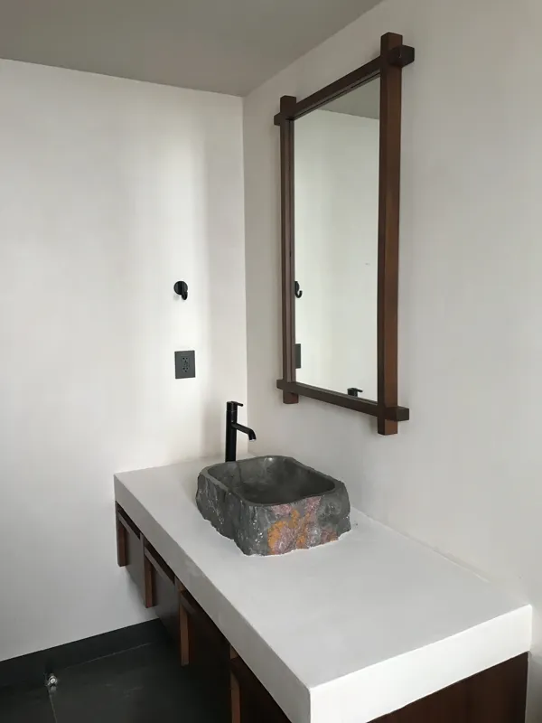 A series of eight photographs depicting the finished interiors and private rooftop amenities of a residential unit within the Humana development in Tulum. Images include a spacious living area with dark tiled floors and large glass doors, a modern...