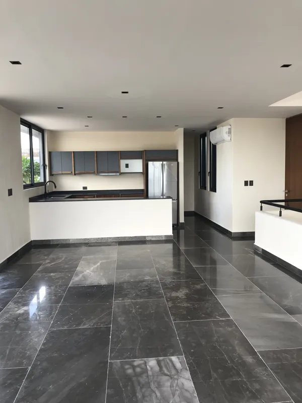 A series of eight photographs depicting the finished interiors and private rooftop amenities of a residential unit within the Humana development in Tulum. Images include a spacious living area with dark tiled floors and large glass doors, a modern...