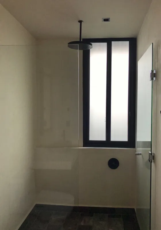 A series of eight photographs depicting the finished interiors and private rooftop amenities of a residential unit within the Humana development in Tulum. Images include a spacious living area with dark tiled floors and large glass doors, a modern...