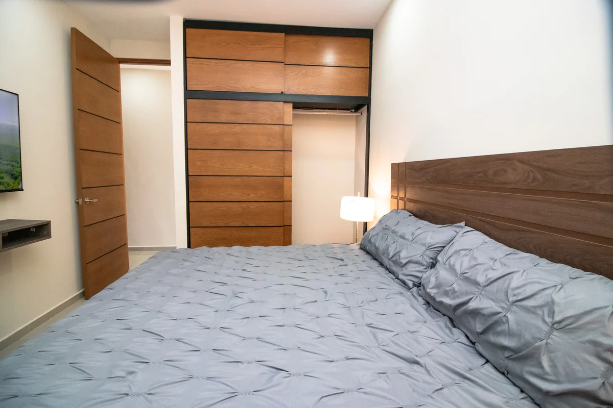 View of Bedroom at Torre 25, showcasing Modern Interior, Wood Headboard.