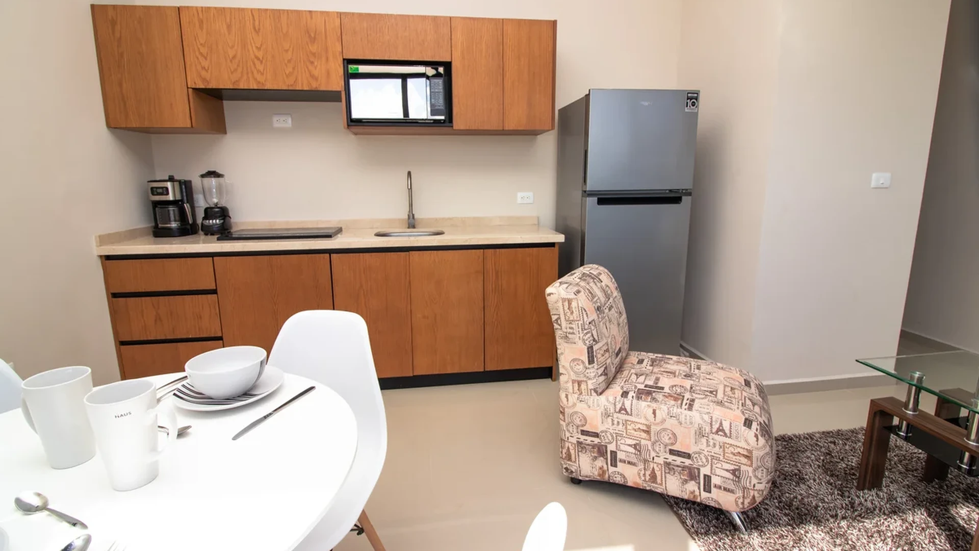 View of Compact Kitchen at Torre 25, showcasing Modern Kitchenette, Dining Area.