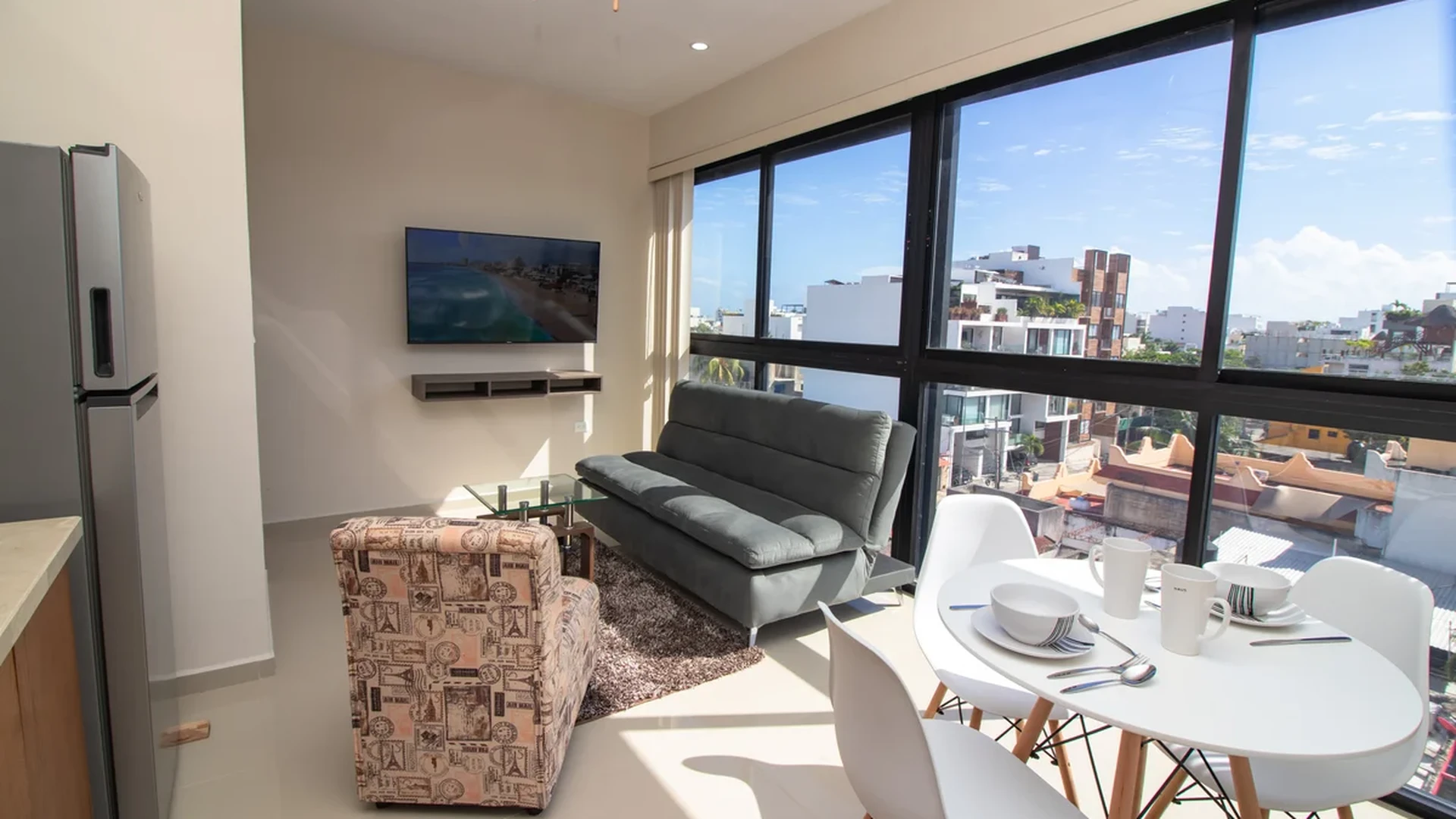 View of Modern Living Room at Torre 25, showcasing Dining Area, City View.