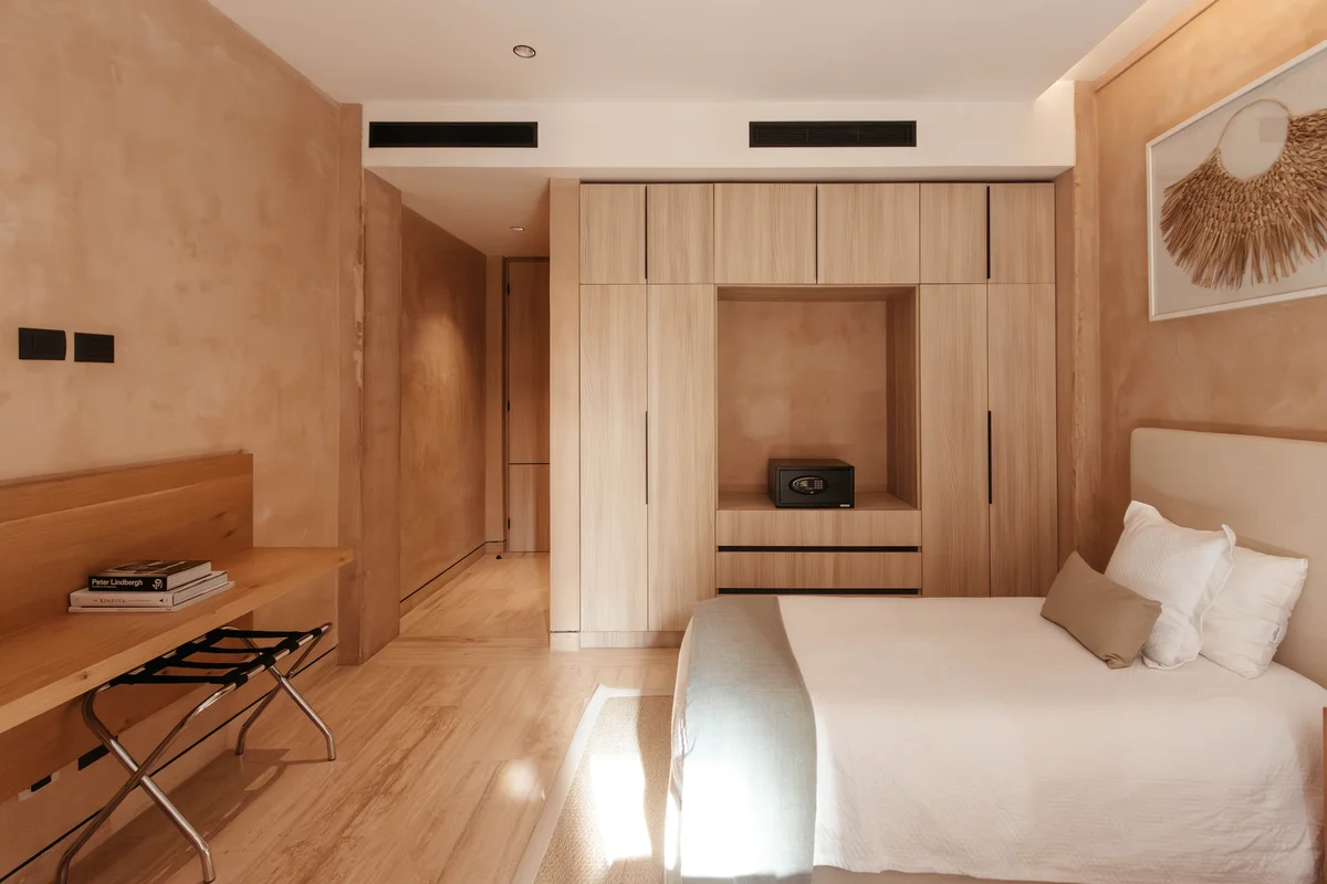 View of Modern Bedroom at The Village, showcasing Neutral Decor, Wood Cabinetry.