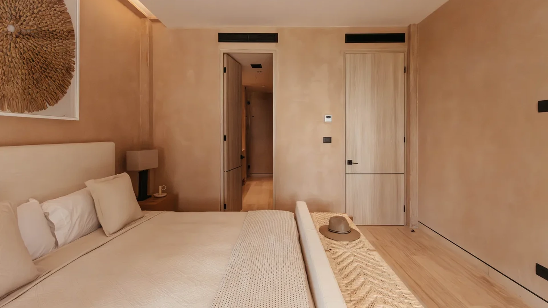 View of Modern Bedroom at The Village, showcasing Neutral Decor, Wood Flooring.