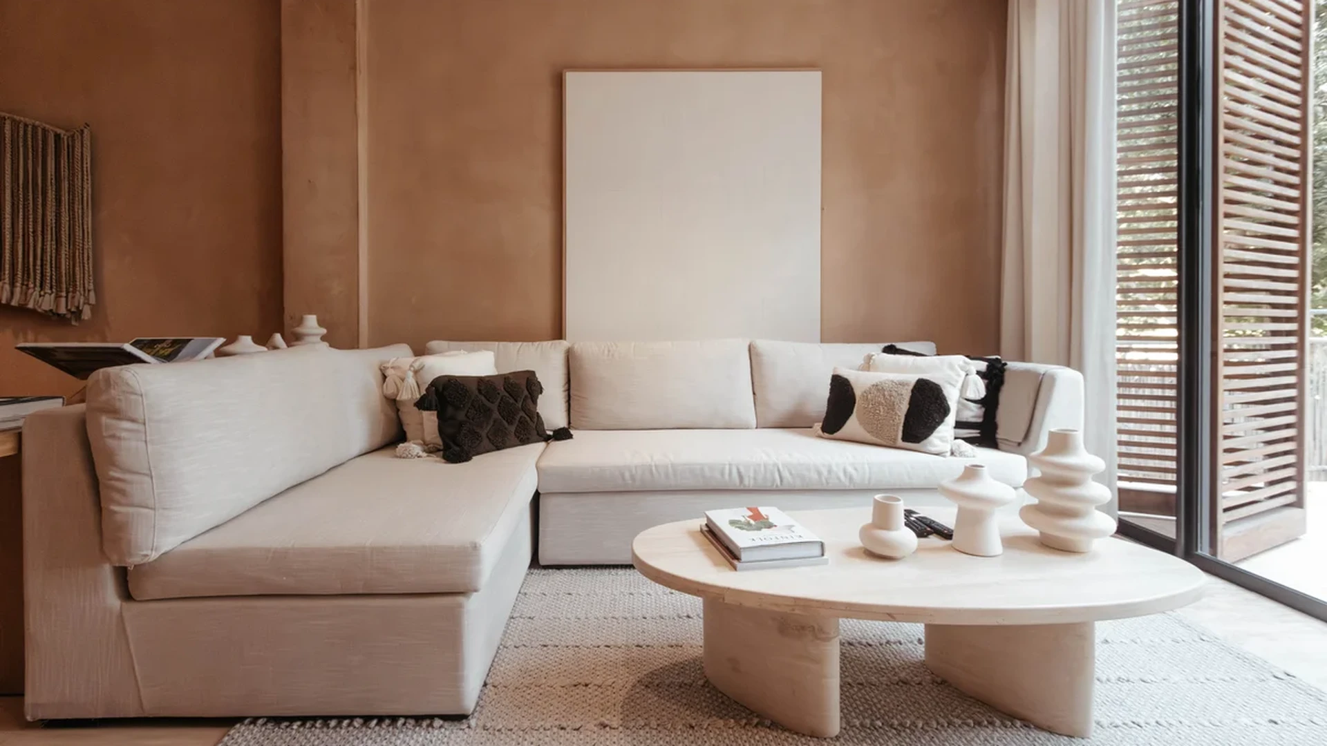 View of Modern Living Room at The Village, showcasing Sectional Sofa, Natural Light.