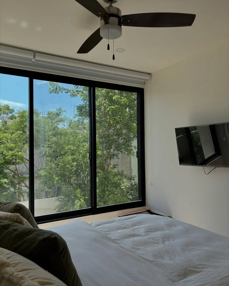 View of Bedroom Interior at Poc Ta Poc, showcasing Natural Light, Large Windows.
