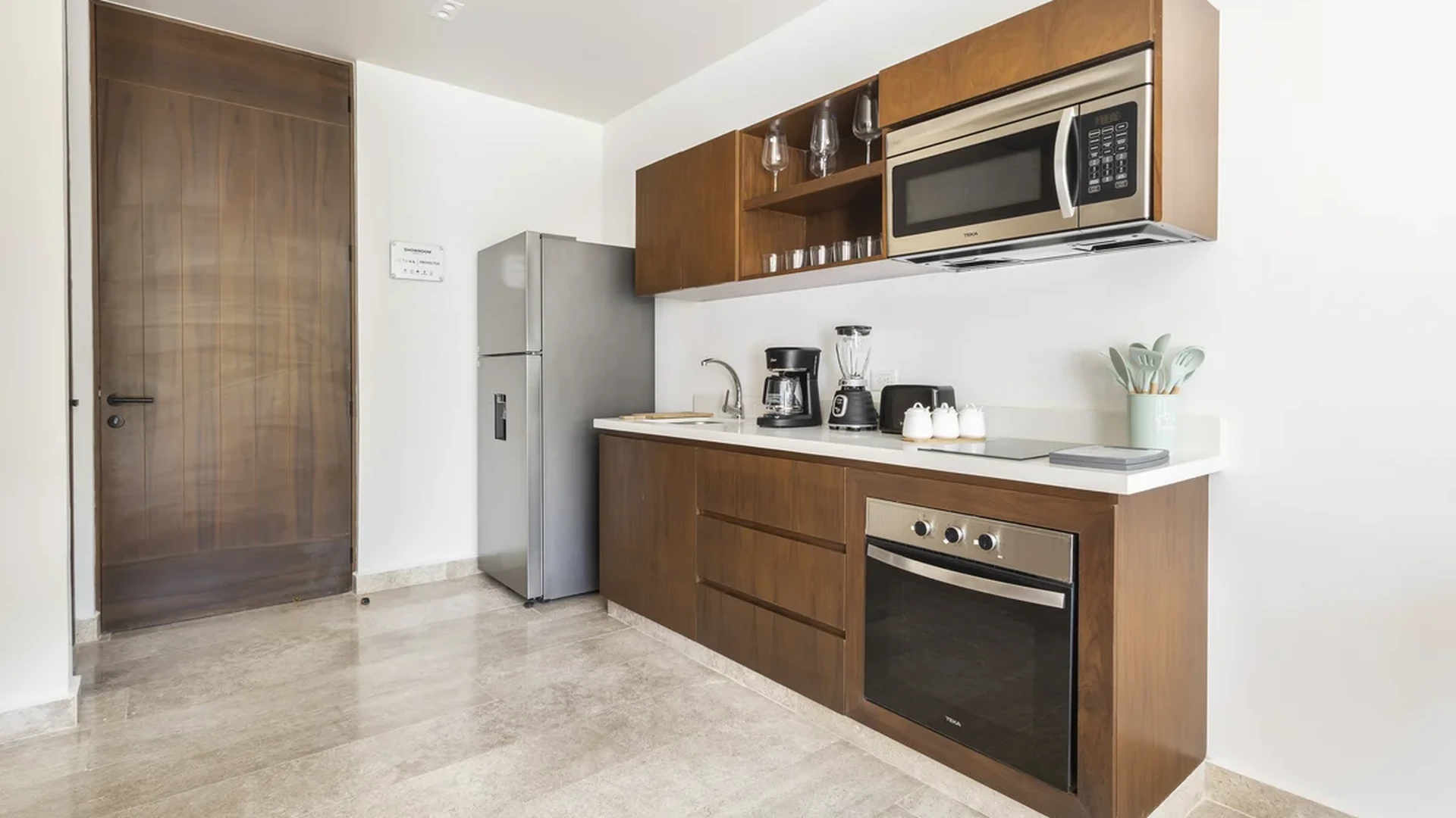 View of Compact Kitchen at Peregrina, showcasing Modern Kitchen, Stainless Steel Appliances.